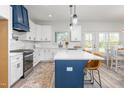 Well-lit kitchen featuring white cabinets, stainless steel appliances, and a center island at 4037 Mebane Oaks Rd, Mebane, NC 27302