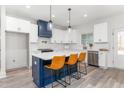 Bright eat-in kitchen with white cabinets, stainless appliances, and a blue island at 4037 Mebane Oaks Rd, Mebane, NC 27302