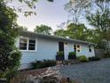 Charming home featuring a well-maintained lawn, stone accents, and a cozy front porch at 424 S Greensboro St, Carrboro, NC 27510