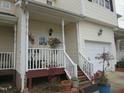 Inviting front porch with flowers, stairs, and white railings, adding to curb appeal at 4245 Toccopola St, Raleigh, NC 27604