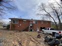 View of the home's rear exterior, featuring a small garage and a stairway to the second floor at 4308 Old Chapel Hill Rd Rd, Durham, NC 27707