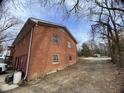 Back exterior of home, with potential access for garage or storage area at 4308 Old Chapel Hill Rd Rd, Durham, NC 27707