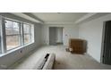 Large bedroom showcasing tray ceiling and a doorway leading to an adjacent room at 46 Shortstop Cir, Four Oaks, NC 27524