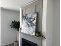 Elegant gray fireplace with a decorative mantel and modern artwork at 46 Shortstop Cir, Four Oaks, NC 27524