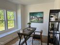 Bright office space with a large window, rustic desk, and stylish decor at 46 Shortstop Cir, Four Oaks, NC 27524