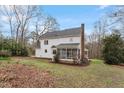 View of home exterior featuring a screen porch and a well-maintained backyard at 5044 Allanbrooke Ln, Fuquay Varina, NC 27526