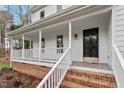 Inviting covered front porch with white railings and brick steps leading to the entrance at 5044 Allanbrooke Ln, Fuquay Varina, NC 27526