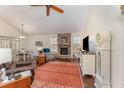 Open living room features stone fireplace, high ceilings, and ample natural light at 580 Long View Dr, Youngsville, NC 27596