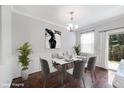 Elegant dining room featuring modern decor, hardwood floors, and natural light at 6233 Pesta Ct, Raleigh, NC 27612