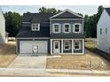 Charming two-story home featuring a covered entry, attached garage, and a classic blue and white color scheme at 704 Compeer Way # 28, Rolesville, NC 27571