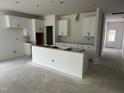 Kitchen with white cabinets and a central island at 704 Compeer Way # 28, Rolesville, NC 27571