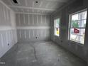 Bright, unfinished living room featuring large windows for ample natural light at 704 Compeer Way # 28, Rolesville, NC 27571