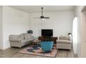 Cozy living room with comfortable seating, a modern ceiling fan, and decorative rug at 735 Alexander Ave, Henderson, NC 27536