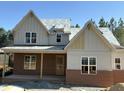 New construction home featuring a brick and siding exterior with modern architectural details at 829 Chapel Ridge Dr, Pittsboro, NC 27312