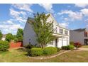 View of the side of a two-story home featuring an attached garage at 1009 Limeberry Ct, Clayton, NC 27520