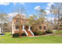Charming brick home featuring a well-manicured lawn and inviting entrance stairs at 101 Redfoot Run Rd, Chapel Hill, NC 27516