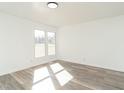 Bright bedroom featuring stylish flooring, fresh white walls, and ample natural light at 1018 Roxboro St, Haw River, NC 27258