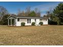 Lovely single-story home with covered parking. Features an inviting exterior and well-maintained lawn at 1018 Roxboro St, Haw River, NC 27258