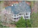 Stunning aerial view shows the home's secluded location surrounded by mature trees and lush greenery at 104 Sierra Dr, Chapel Hill, NC 27514