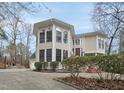 Elegant two-story home features large windows, a paver driveway, and meticulously maintained landscaping at 104 Sierra Dr, Chapel Hill, NC 27514