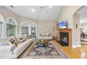 Warm living room featuring hardwood floors, a cozy fireplace, and modern furnishings at 104 Sierra Dr, Chapel Hill, NC 27514