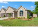 Beautifully landscaped yard and well-maintained front exterior featuring a two-car attached garage at 1053 Beechcraft Dr # 124, Mebane, NC 27302