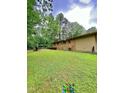 Large backyard with brick patio, partial privacy fence and mature trees at 1115 Park Ave, Henderson, NC 27536