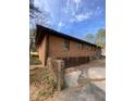 View of the home's brick exterior and well-maintained backyard, offering privacy and a welcoming space at 1115 Park Ave, Henderson, NC 27536