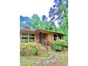 Close up of a well-maintained brick home with stone walkway and mature landscaping at 1115 Park Ave, Henderson, NC 27536