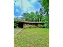 Charming single-story brick home with a carport and well-maintained lawn at 1115 Park Ave, Henderson, NC 27536