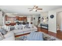 Open-concept living room showcasing hardwood floors, a ceiling fan, and a comfortable sectional sofa at 1207 Colton Creek Rd, Knightdale, NC 27545