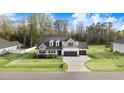 Charming two-story home with well-manicured lawn and a three-car garage at 147 Everwood Dr, Four Oaks, NC 27524