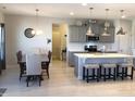 Modern kitchen with an island, stainless steel appliances, and stylish pendant lighting at 149 Steep Rock Dr, Willow Springs, NC 27592