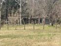 Large backyard view featuring open space, a rustic fence, and an interesting wooded backdrop at 1509 Smith Level Rd, Chapel Hill, NC 27516