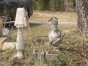 Yard decor with a classic stone bust, adding character to the natural garden setting at 1509 Smith Level Rd, Chapel Hill, NC 27516
