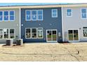 Spacious backyard featuring sod, sliding glass doors, and ample natural light at 162 Nimble Way # 225, Clayton, NC 27520