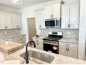 Bright kitchen featuring granite countertops, stainless steel appliances, and stylish backsplash at 162 Nimble Way # 225, Clayton, NC 27520