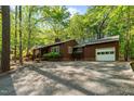 Single-story home with attached garage, large driveway, well-kept landscaping and beautiful trees at 1801 Irish Blvd, Sanford, NC 27332