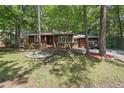 Traditional single-story home on a large, shaded lot with mature trees and long driveway at 1801 Irish Blvd, Sanford, NC 27332