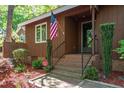 Inviting brick front porch featuring manicured landscaping, CPI security, and an American flag at 1801 Irish Blvd, Sanford, NC 27332