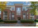 Attractive brick apartment building with multiple windows, small balconies, and landscaped entry at 201 Finsbury St # 201, Durham, NC 27703