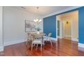 Dining room with hardwood floors, blue accent wall and stylish chandelier, creating a welcoming atmosphere at 201 Finsbury St # 201, Durham, NC 27703