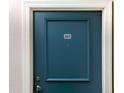 Close-up of a dark blue, apartment front door with '201' room number and stainless steel handle at 201 Finsbury St # 201, Durham, NC 27703