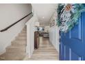 Inviting entryway with wood-look flooring, staircase, and a view into the bright and open living space at 25 Carlton Ln, Franklinton, NC 27525
