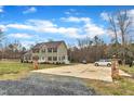 View of the home, driveway and parking featuring a brick mailbox, mature trees and landscaping at 250 Spring View Ln, Pittsboro, NC 27312
