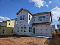 New home construction featuring multiple windows and back patio, set on a dirt lot in a residential neighborhood at 3015 Dog Rose Drive Lot 170 Dr, Durham, NC 27703