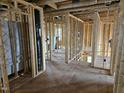 Interior of unfinished new construction home featuring exposed framing, HVAC duct work, and plywood flooring at 3015 Dog Rose Drive Lot 170 Dr, Durham, NC 27703