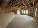 Unfinished living room featuring wood framing, a fireplace, and natural light at 3015 Dog Rose Drive Lot 170 Dr, Durham, NC 27703