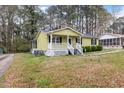 Quaint single-story home with a welcoming front porch and a lush lawn at 304 22Nd St, Butner, NC 27509