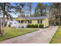 Charming one-story home featuring a covered front porch and driveway at 304 22Nd St, Butner, NC 27509